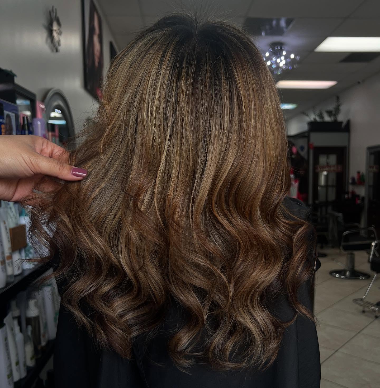 Brunette balayage with honey-toned waves, seen from the back