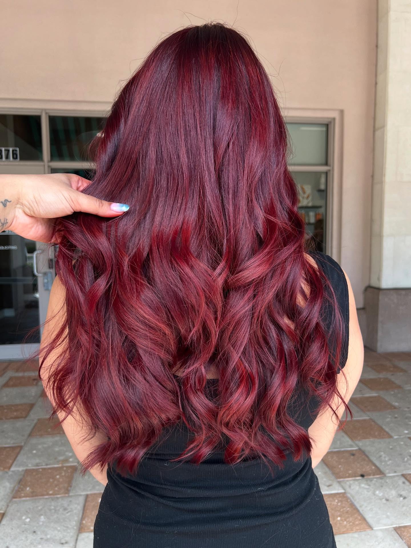 Deep cherry red in long, full waves