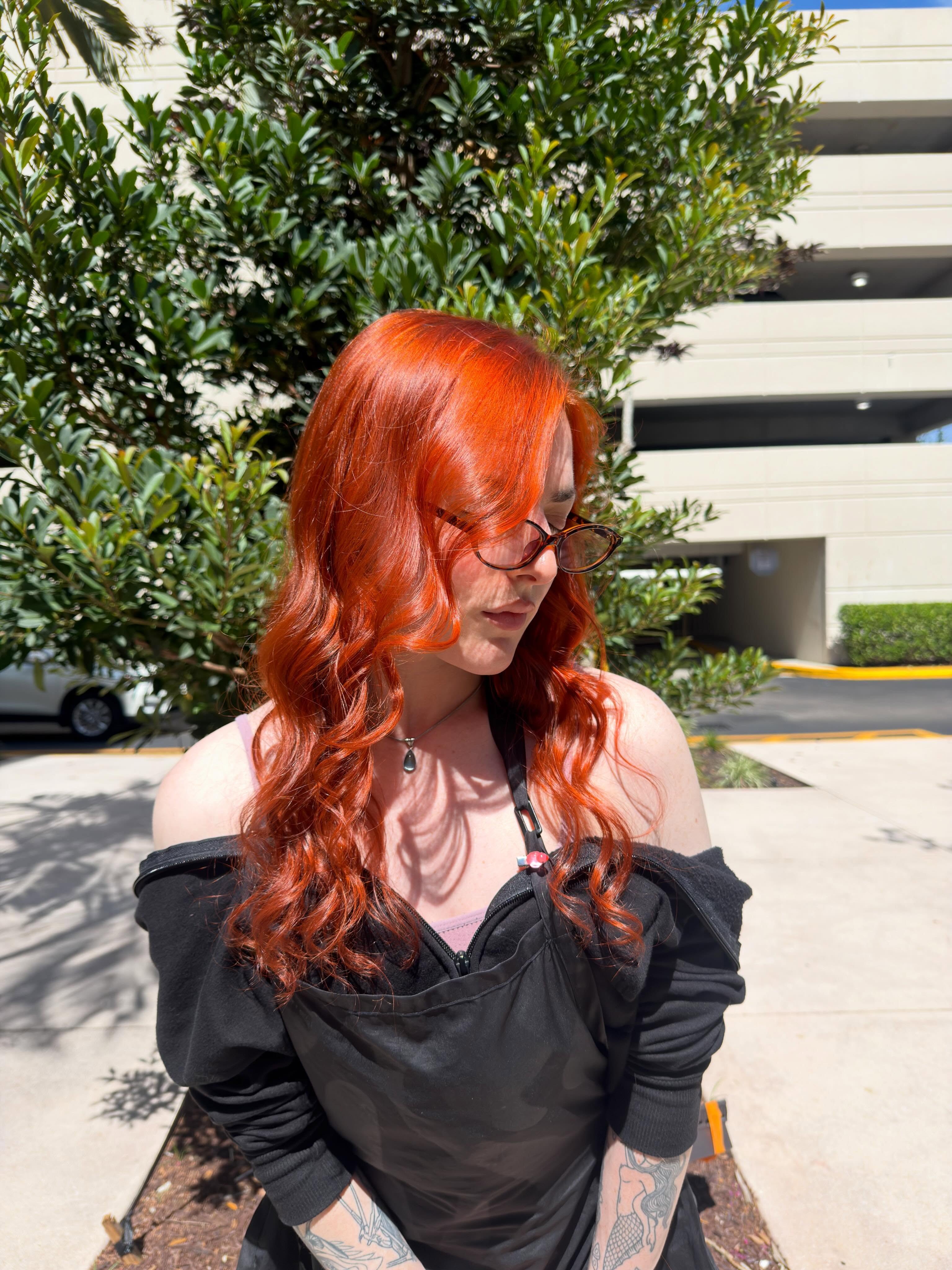Vivid copper refresh with face-framing layers and a glossy finish