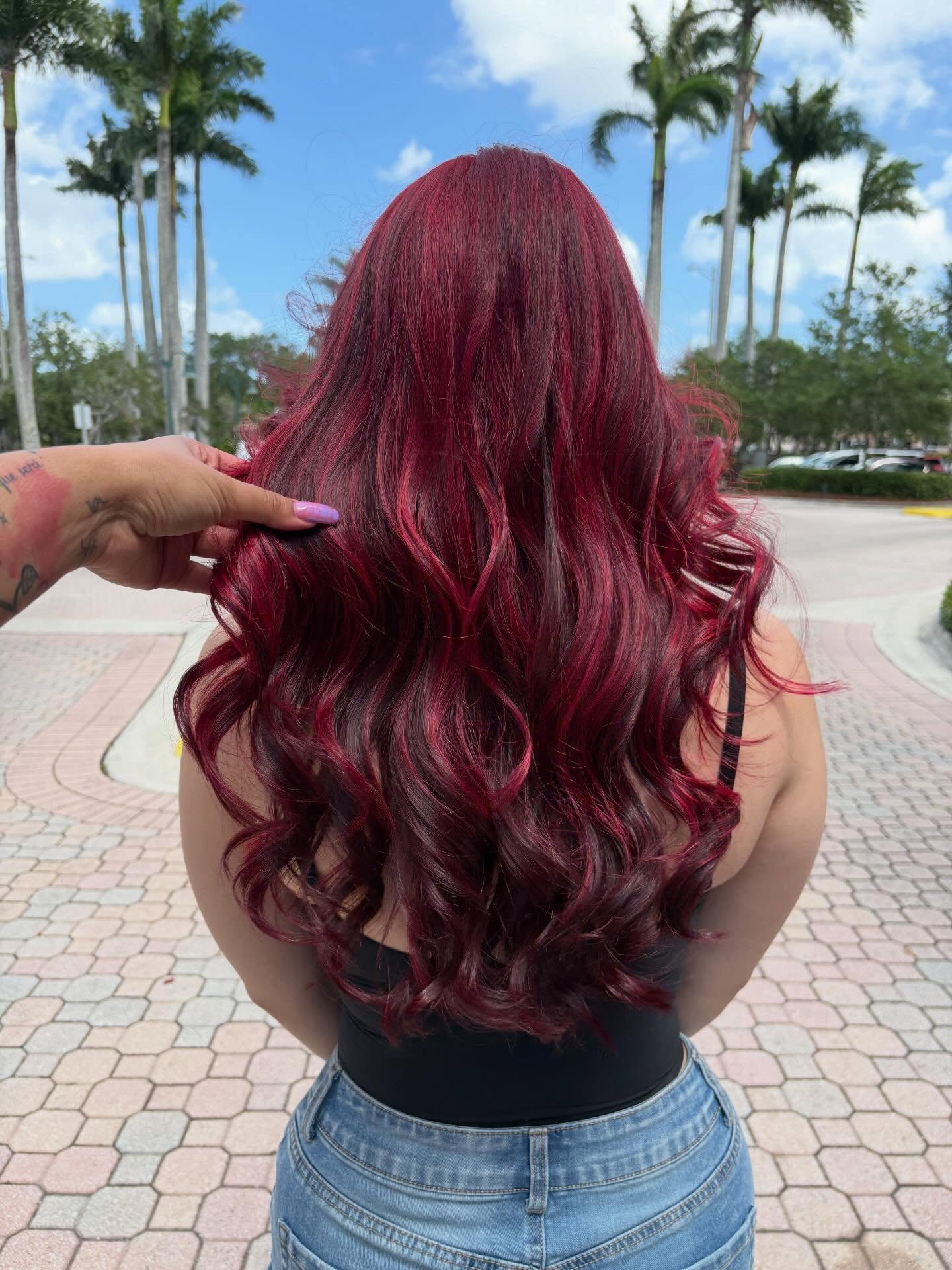 Rich dimensional red in long, glossy curls