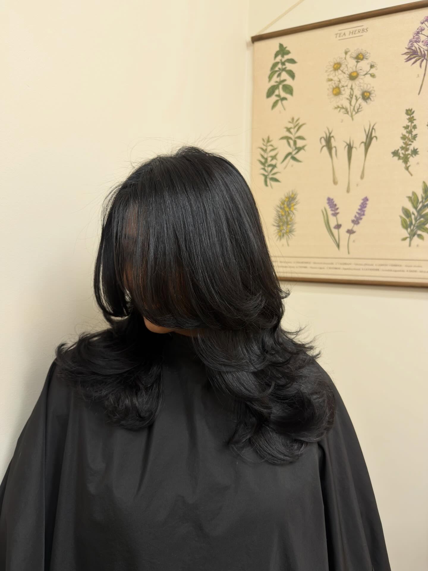 Luminous dark hair in a layered cut with face-framing movement