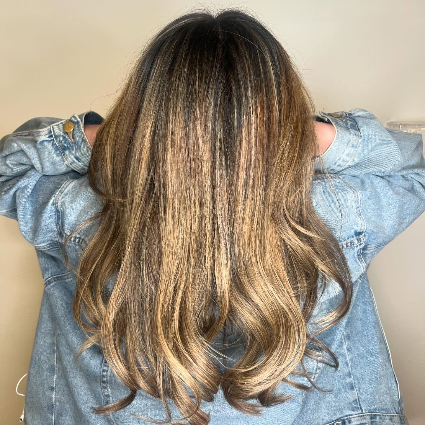 Sandy blonde highlights through long, freshly layered waves