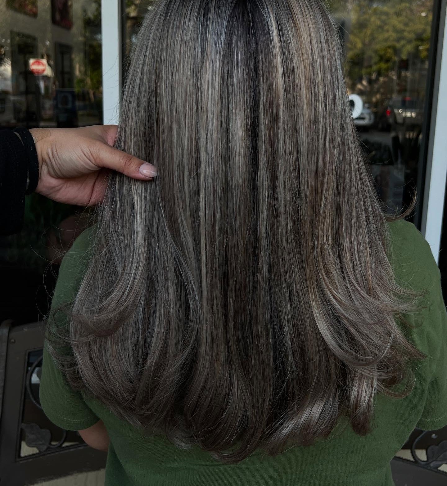 Grey blending with soft ash highlights through shoulder-length layers